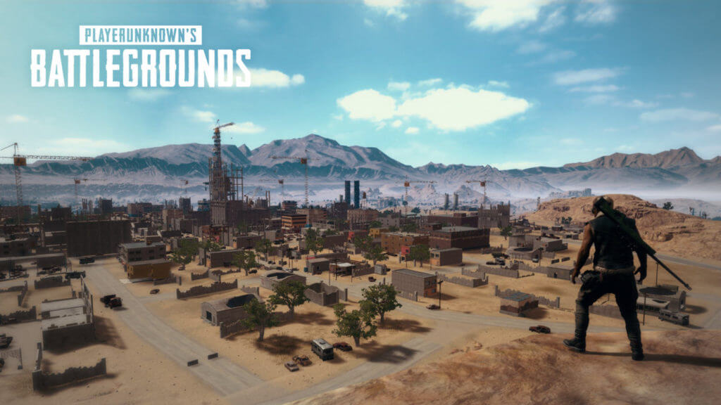 PubG - A man standing on a hill looking at a deserted town